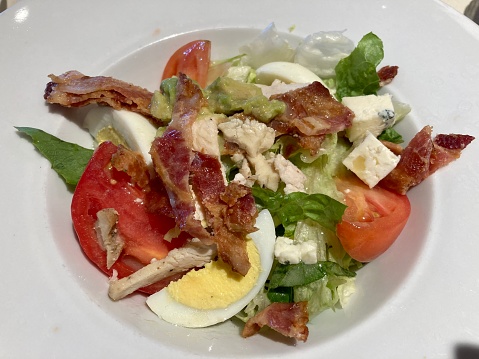 Cobb salad with eggs, tomatoes, chicken and bacon