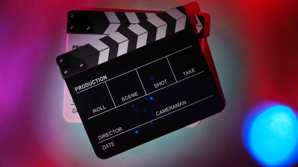 istock Black and white Clapperboard or movie slate on multi color background. 1418501097