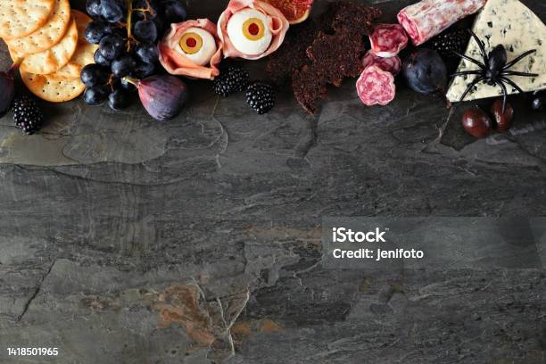 Halloween Charcuterie Top Border Against A Dark Stone Background Stock Photo - Download Image Now