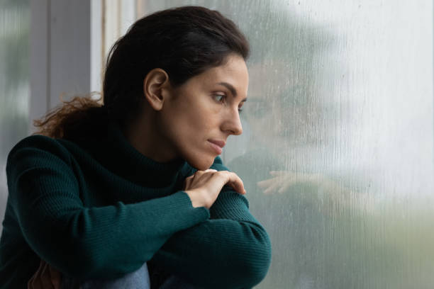 stressed young hispanic woman suffering from negative thoughts. - window home interior women people imagens e fotografias de stock