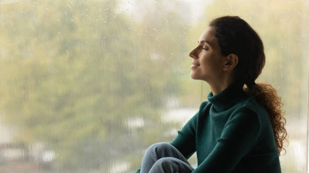 istock Dreamy happy young hispanic woman meditating indoors. 1418507721