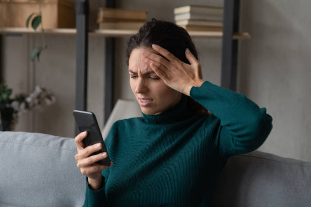 istock Stressed unhappy young woman getting message with bad news. 1418507733