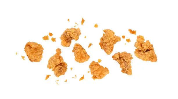 Photo of Fried popcorn chicken with crumbs isolated on white