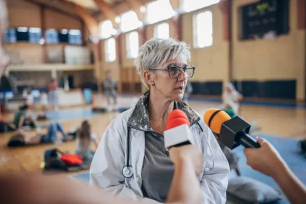 Photo of Press talking to a army doctor