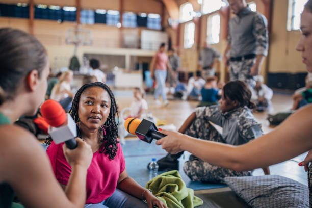 istock Press talking to civilians in shelter 1418513192