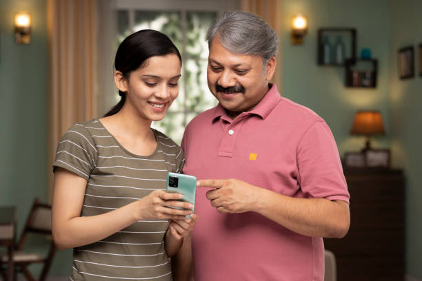 istock daughter her father spend time together using phone stock photo 1418515385