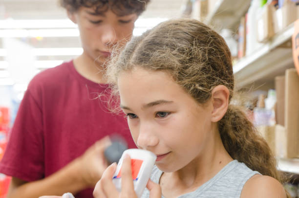 Teenagers shopping for deodorant stock photo