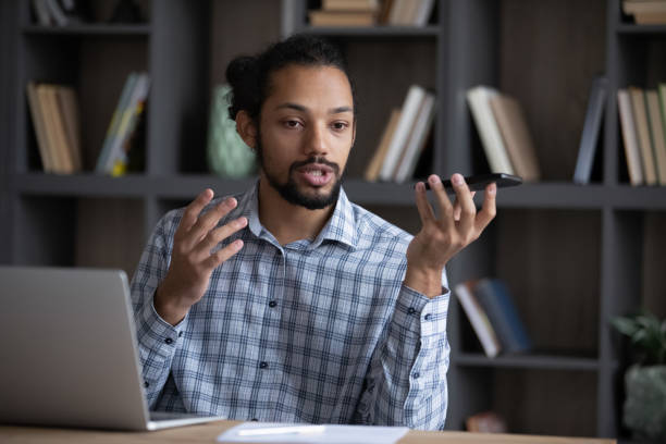 istock Serious Afro American freelancer man giving voice command 1418516212