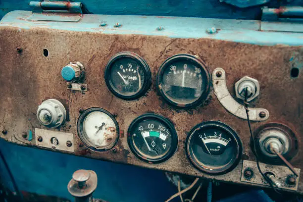 Photo of The rusty steel dashboard of a very old tractor close-up