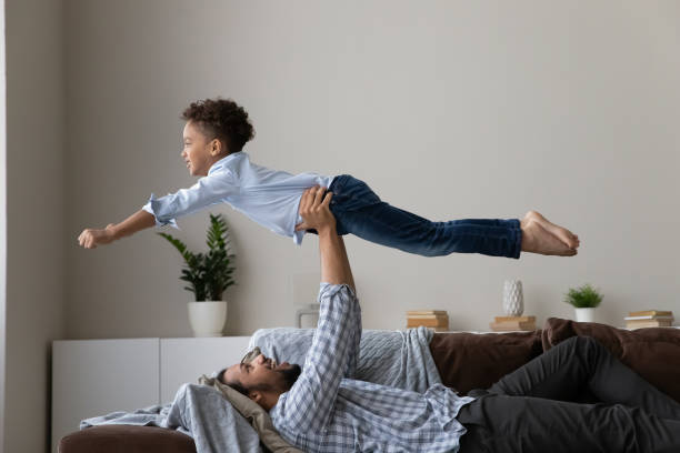 istock Happy African daddy playing sportive games with active little son 1418516778