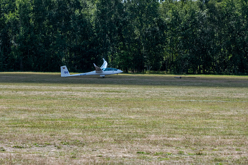 Hamburg, Germany - 08 21 2022: a glider pilot is pulled by a rope for take-off