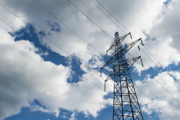 Transmission tower of high voltage overhead power lines, symbol of electricity, distribution of energy