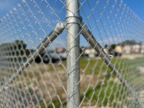 view to a wire mesh fence fixed at a metal post