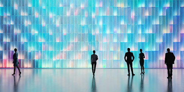 Business people in front of a wall made of illuminated rectangular shapes. All objects in the scene are 3D