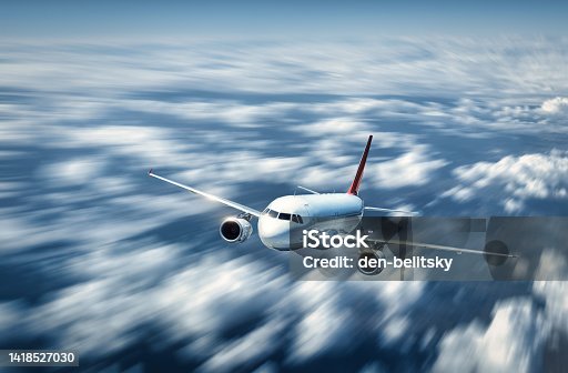 istock Airplane is flying above the low clouds in summer. Landscape with passenger airplane and blurred background. Aircraft is taking off. Business travel. Commercial plane. Aerial view. Transport 1418527030