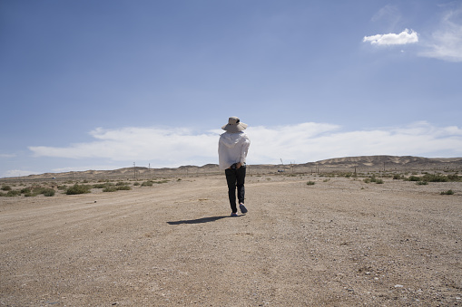 A man walking alone in the desert
