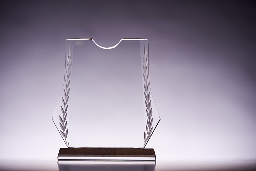 crystal trophy award against gray backgound