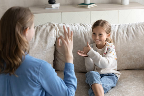 istock Happy little kid and mom speaking sign language 1418536386