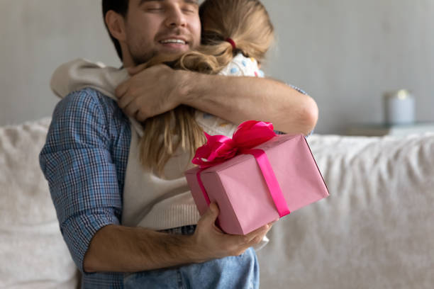 istock Happy grateful devoted dad hugging little daughter girl with gratitude 1418536412