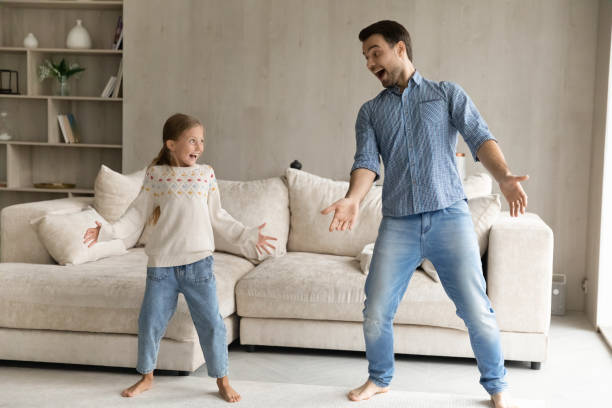 istock Funny crazy dad and kid dancing to music 1418536510