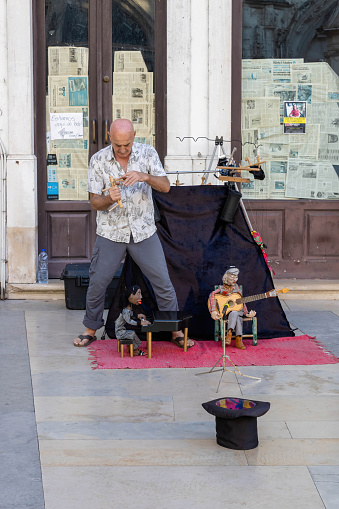 Coimbra, Portugal - July 5, 2022: An artist performing a puppet show.