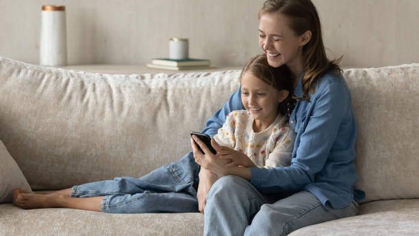 istock Happy mom and kid using online ecommerce app on smartphone 1418536639