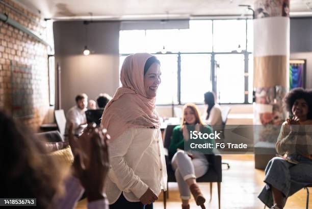 Mature Muslim Woman Giving A Lecture In An University Or Group Therapy Stock Photo - Download Image Now