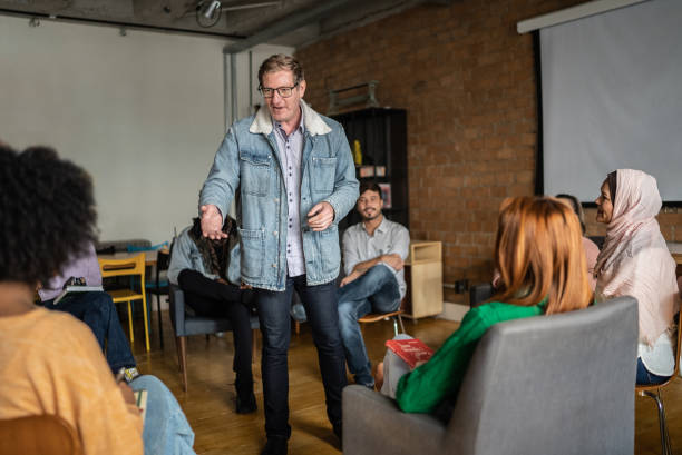 istock Mature man giving a lecture in an university or group therapy 1418536794