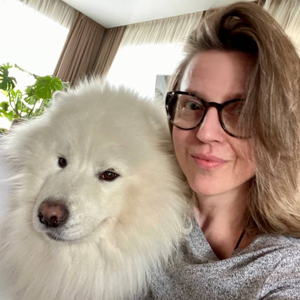 istock Woman with Samoyed dog self portrait 1418538917
