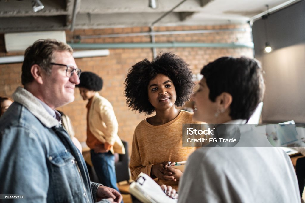 Students or business people talking in the classroom or networking event Meet And Greet Stock Photo