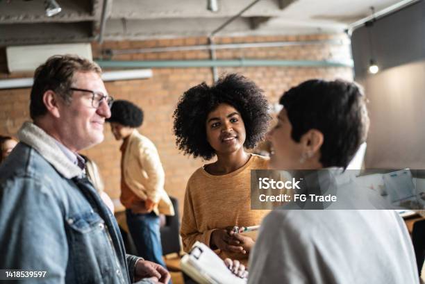 Students Or Business People Talking In The Classroom Or Networking Event Stock Photo - Download Image Now
