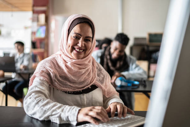 istock Portrait of a mature woman using computer in classroom at university 1418540826