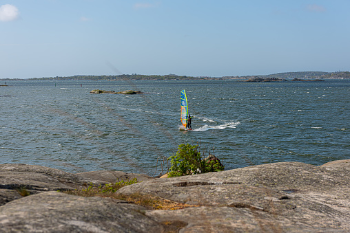 Gothenburg, Sweden - May 07 2022: Wind surfing in fresh breeze by Fiskebäck.