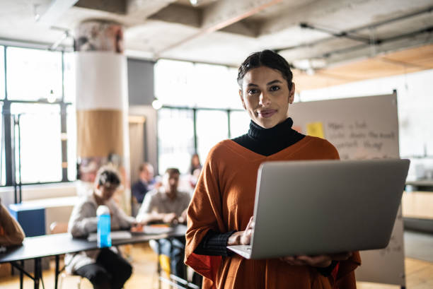 Portrait of a young woman using the laptop in the classroom Portrait of a young woman using the laptop in the classroom self improvement stock pictures, royalty-free photos & images