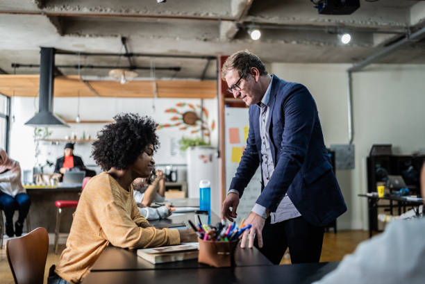 istock Teacher talking to student in the classroom 1418544063