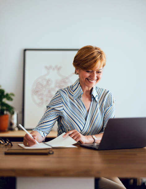 istock Happy Senior Woman Using Laptop Computer At Home 1418544724
