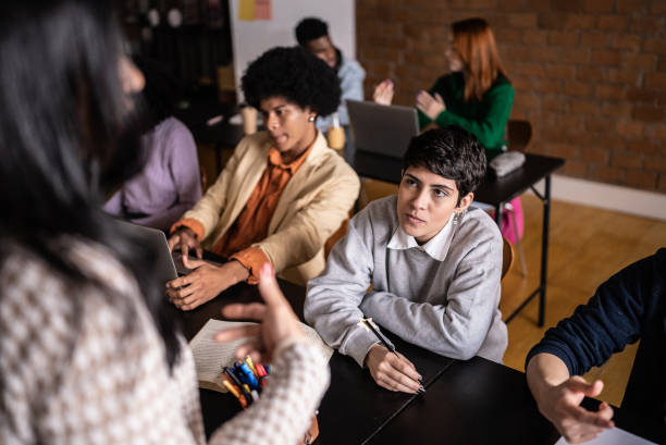 istock Young students talking to the teacher during class in the university 1418549053