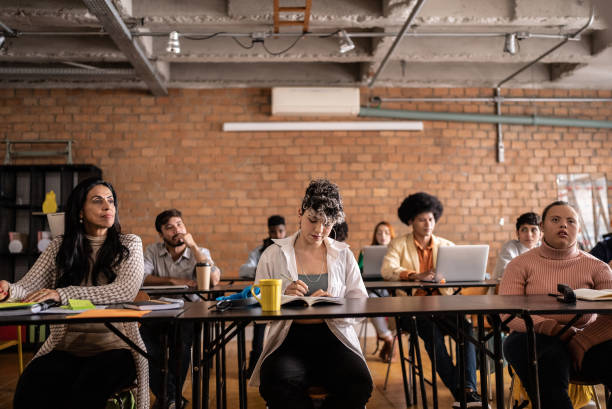 istock Students during class in the university - including a person with special needs 1418549136