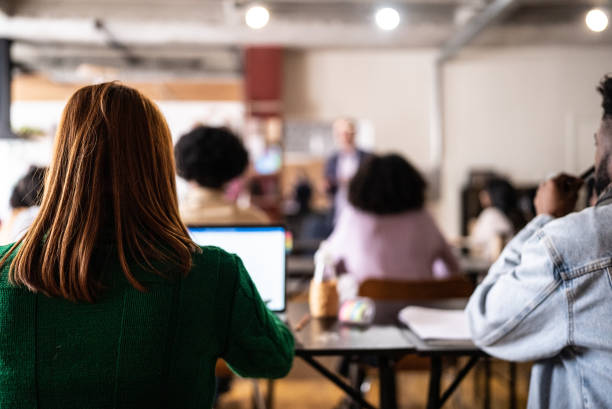 Young woman during class in the university Young woman during class in the university lecture hall training classroom presentation stock pictures, royalty-free photos & images