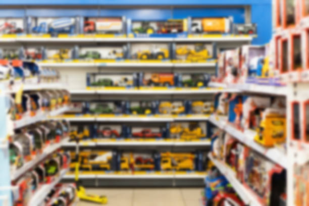 Blurred image of shelves with toy cars in a toy shop. Blurred image of shelves with toy cars in a toy shop. toy store stock pictures, royalty-free photos & images