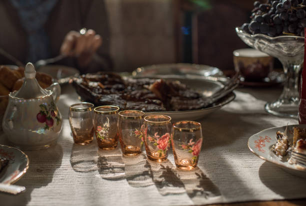 istock Festive table during Slavic holidays. Table with old style vodka glasses. 1418553228