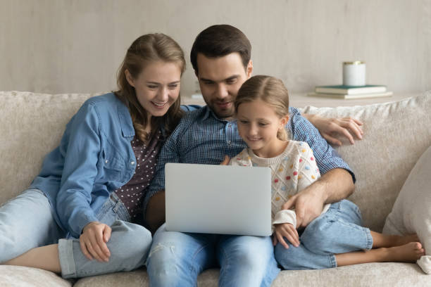 istock Happy parents and daughter kid shopping on internet 1418553731