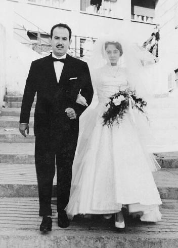 Vintage image from the 50s : Young couple walking from the church after getting married