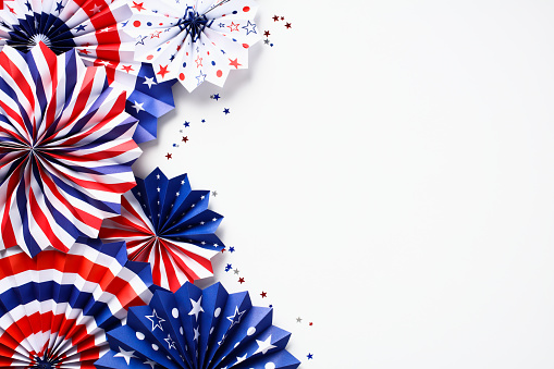 4th of July American Independence Day, Columbus Day, Labor day holiday composition. Red white and blue paper fans and confetti isolated on white background