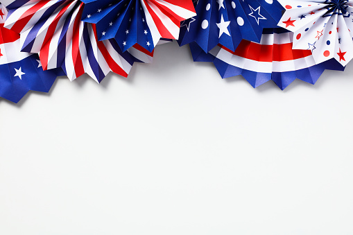 Happy Labor Day banner mockup. American flag color paper fans isolated on white background. Flat lay, top view.