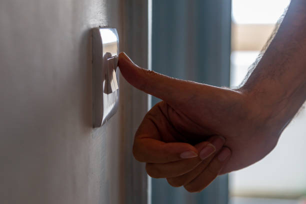 istock A close up of a man switching off a light switch 1418571142