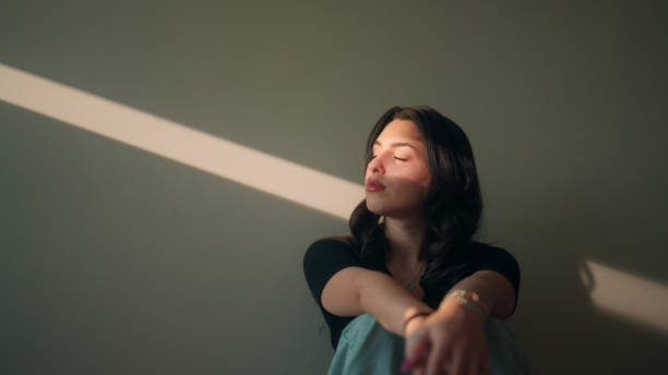 Portrait of fashioanable young woman lit by sunlight stock photo