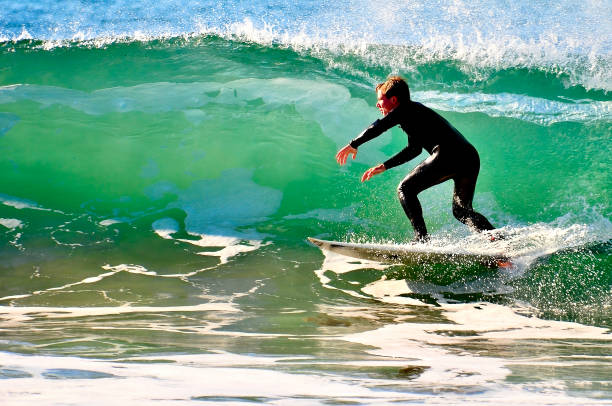 istock Surfer racing the lip of a crashing wave 1418579971