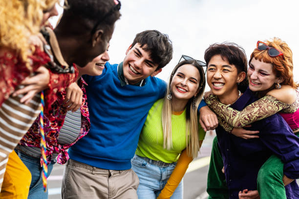 Happy young diverse friends having fun hanging out together - Youth people millennial generation concept stock photo