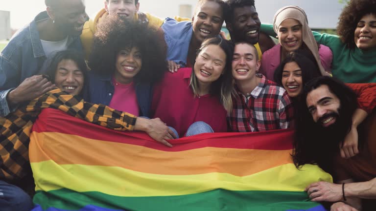 Happy diverse young friends celebrating gay pride festival - LGBTQ community concept